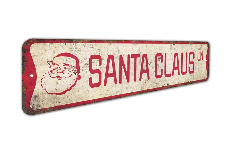 a santa claus sign hanging on a wall