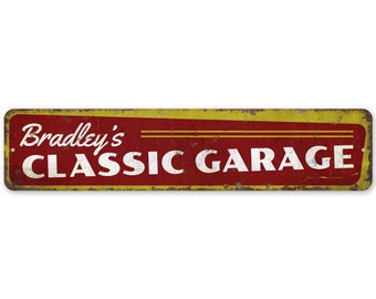 May include: A vintage-style metal sign with a red background and yellow border. The sign reads "Bradley's Classic Garage" in white lettering.