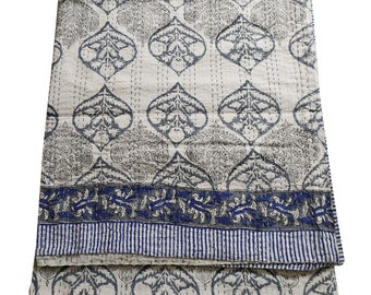 May include: A white cotton kantha quilt with a blue and gray floral pattern. The quilt is folded in half and has a blue and white striped border.