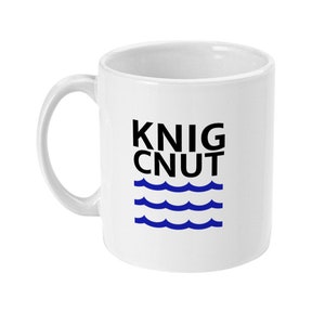 May include: White ceramic mug with a black and blue design. The text "KNIG CNUT" is printed in black, and three blue waves are below the text.
