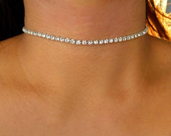 May include: A silver choker necklace with small clear rhinestones.