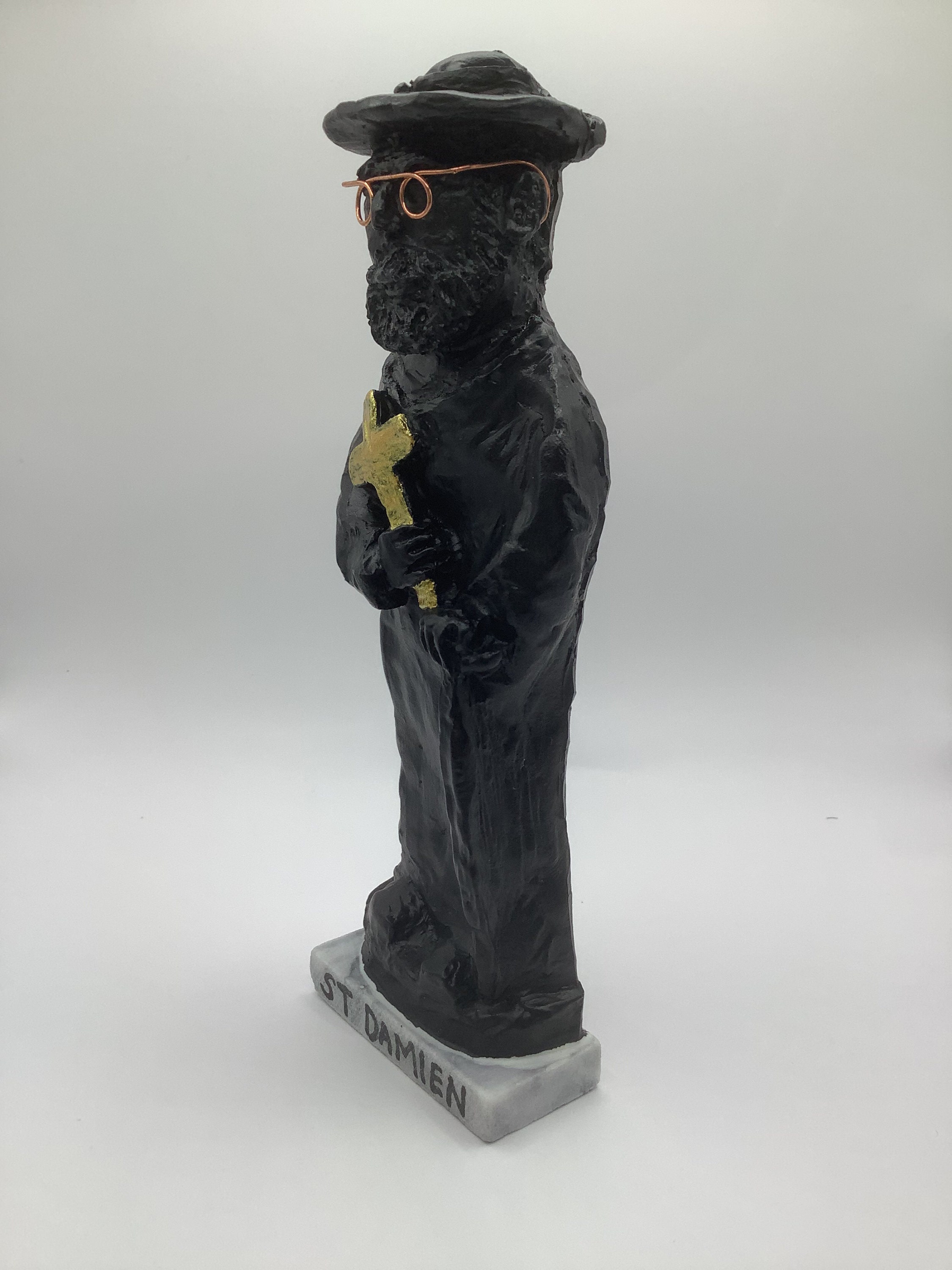 St Damien of Molokai Statue, Lava Rock Black W/ Golden Cross on a
