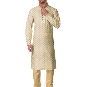 May include: Cream-colored kurta pajama set. The long-sleeved kurta features a gold diamond pattern and a mandarin collar with gold embroidery. The matching pajama pants are a solid cream color. The outfit is completed with black and gold embroidered shoes.