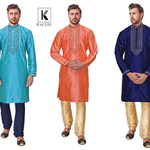 May include: Three silk kurta pajama sets in teal, coral, and navy blue. Each kurta features intricate embroidery around the collar and cuffs. The teal kurta is paired with navy pants, the coral with beige pants, and the navy with beige pants.