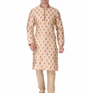 May include: A light gold kurta pajama set. The long-sleeved kurta features a mandarin collar and a repeating gold leaf pattern. The matching pajama pants and shoes complete the ensemble. The text "LightGold-AN823" is in the top left corner.