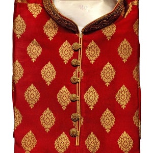 May include: A folded red kurta with a gold floral pattern. The collar and button placket are trimmed with gold beading and a gold border. The kurta has gold buttons and a mandarin collar. The text "Mroon-AN821" is in the top left corner.