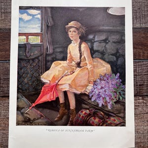 May include: A vintage print titled REBECCA OF SUNNYBROOK FARM featuring a young person with a long braid wearing a light yellow dress, a hat, and brown boots. They are seated holding a red umbrella next to a bouquet of purple flowers and a plaid bag.