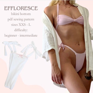 Puede incluir: Un patrón de costura de braga de bikini blanca con ribete y lazos rosas. El patrón está dispuesto sobre un fondo rosa y blanco. El texto "EFFLORESCE" está en la parte superior de la imagen, seguido de "bikini bottom", "pdf sewing pattern", "sizes XXS - L" y "difficulty: beginner - intermediate".