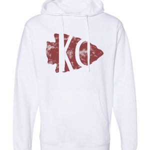May include: White hooded sweatshirt with a red arrowhead design featuring the letters "KO" in white.