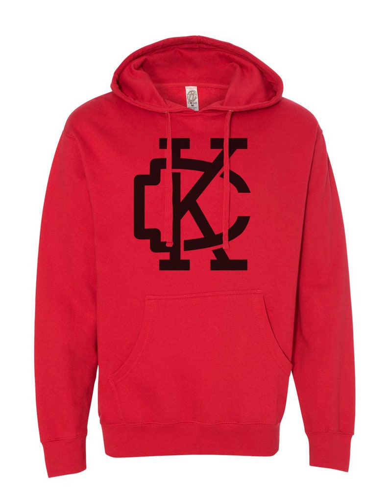 May include: Red hooded sweatshirt with a black "KC" logo on the front.
