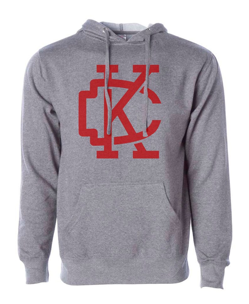 May include: A gray hooded sweatshirt with a red "KC" logo on the front.