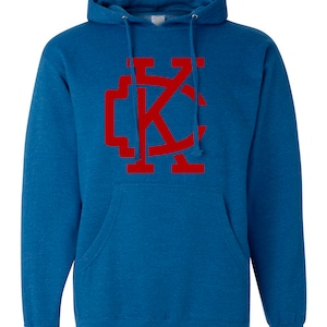 May include: A blue hooded sweatshirt with a red "KC" logo on the front.