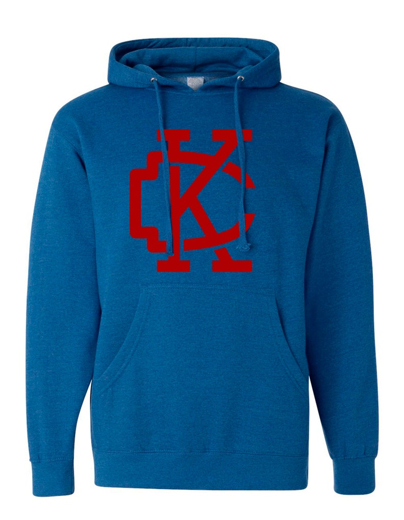 May include: A blue hooded sweatshirt with a red "KC" logo on the front.