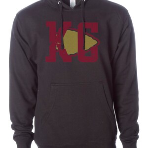 May include: Black hooded sweatshirt with a maroon "KC" graphic featuring a gold arrowhead.