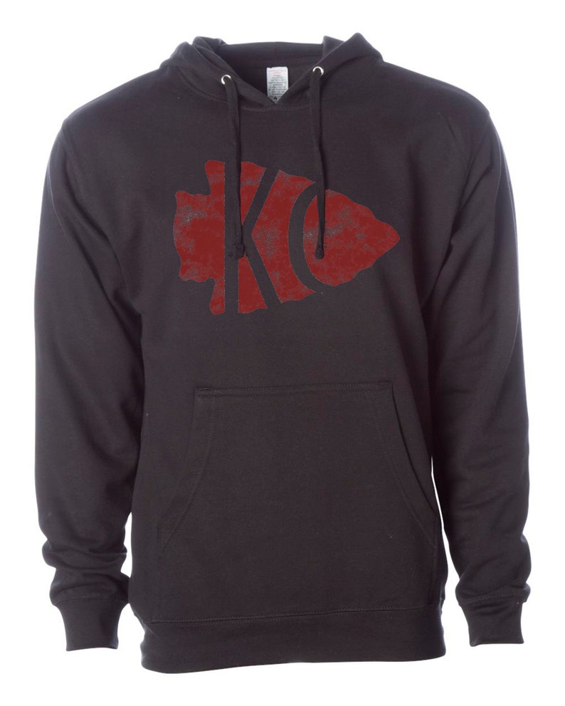 May include: Black hooded sweatshirt with a red distressed arrowhead graphic featuring the letters "KC" inside.
