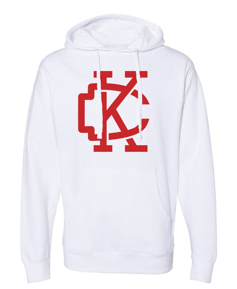 May include: White hooded sweatshirt with a red "KC" logo on the front.