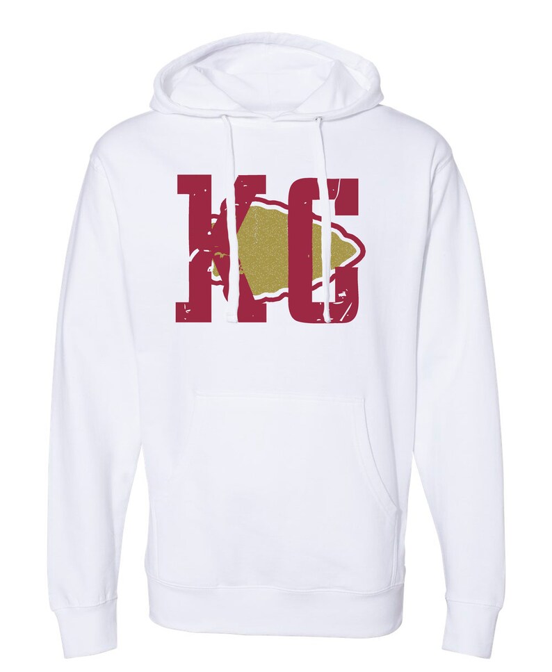 May include: White hooded sweatshirt with a red "KC" logo and a gold arrowhead graphic.