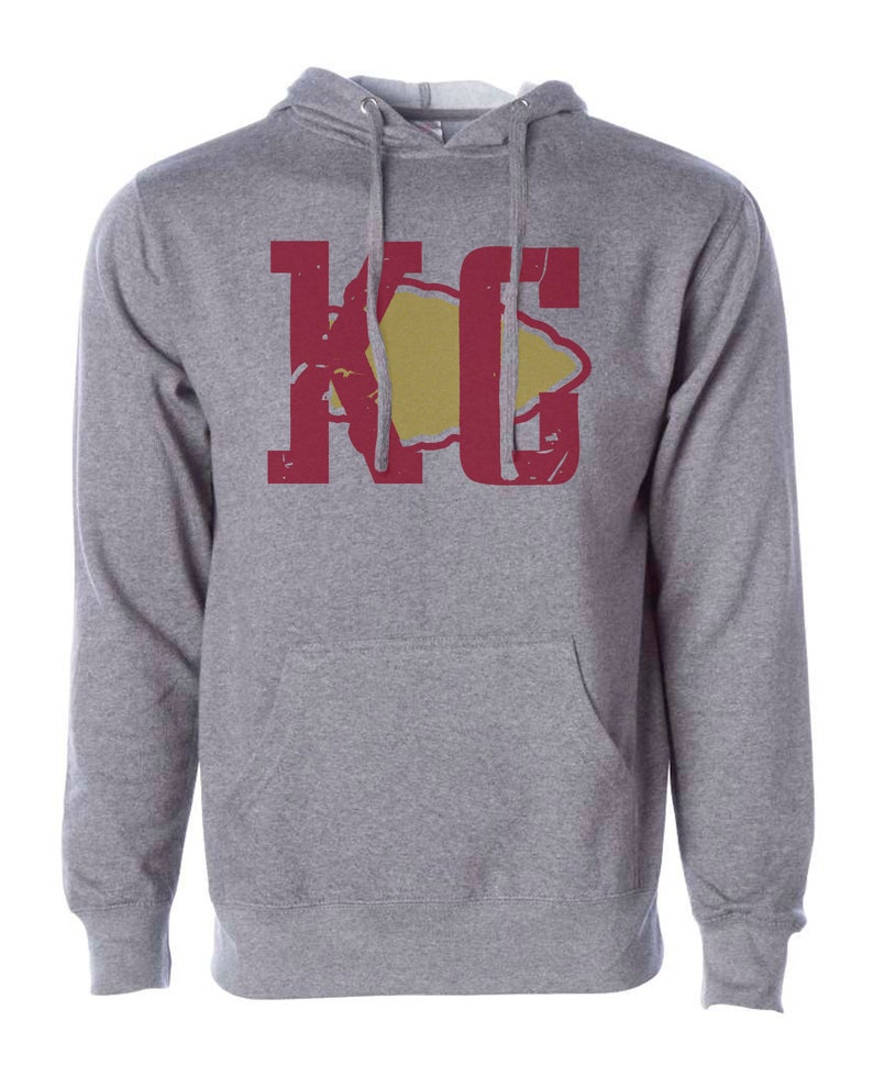 May include: A gray hooded sweatshirt with a red and yellow graphic of the letters "KC" with a stylized arrowhead in the middle.