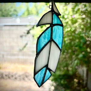 Blue and white stained glass feather