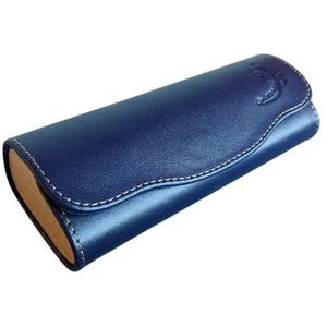 May include: A navy blue leather eyeglasses case with a curved top and white stitching. The case has a light brown interior and a decorative embossed design on the top. The case is designed to protect eyeglasses.