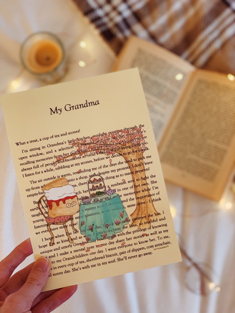 May include: A card featuring a hand-drawn illustration of a cat enjoying a cup of tea and scones. The card has the text "My Grandma" and a poem about the importance of family and memories.