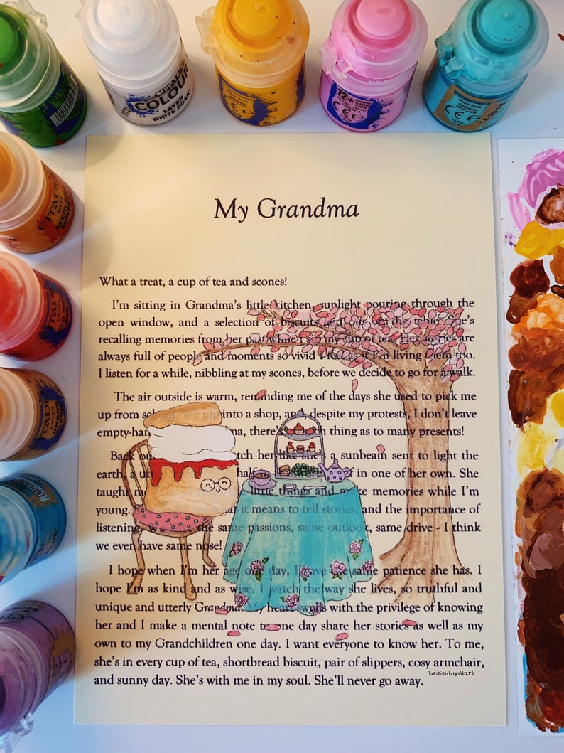 May include: A hand-drawn illustration of a woman sitting at a table with a cup of tea and scones. The illustration is surrounded by paint pots and the text "My Grandma" is at the top of the page. The text below the illustration reads "What a treat, a cup of tea and scones! I'm sitting in Grandma's little kitchen, sunlight pouring through the open window, and a selection of biscuits..."
