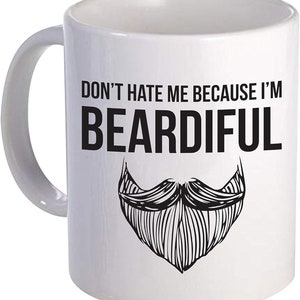 May include: White ceramic mug with a black and white illustration of a beard and the text "Don't hate me because I'm Beardiful".