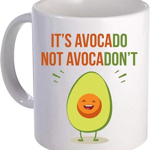 May include: White ceramic coffee mug with a green avocado illustration and the text "It's avocado not avocdon't".