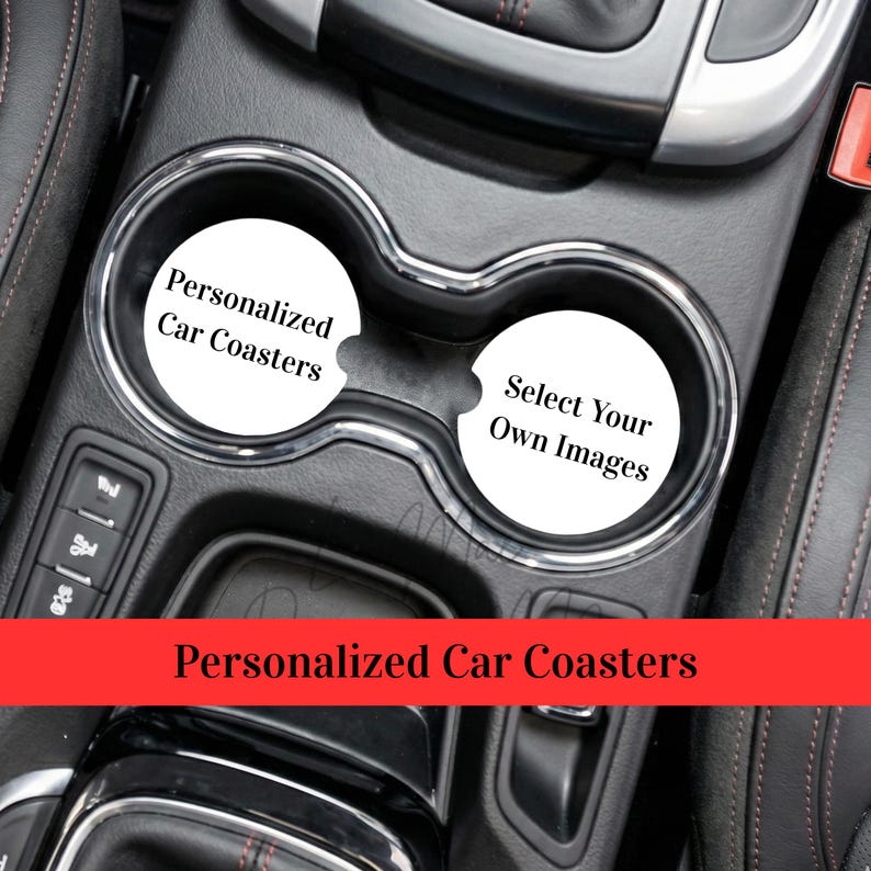 May include: Car interior with two white car coasters. One coaster reads "Personalized Car Coasters" and the other says "Select Your Own Images". The coasters are in a car's cup holders. A red banner at the bottom says "Personalized Car Coasters".