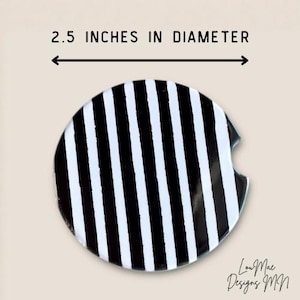 May include: A round car coaster with a black and white striped pattern. The coaster is 2.5 inches in diameter. The design includes a small cutout for easy removal from a car cup holder.