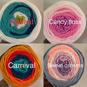 May include: Four skeins of yarn in different color combinations. The yarn is arranged in a circle with the label facing the viewer. The labels read "Upbeat", "Candy floss", "Carnival", and "Sweet dreams".