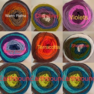 May include: Nine balls of yarn in various color combinations, including warm patina, chambray, violets, terracotta, shoreline, and earthbound. Each ball has a label with the name of the color combination.