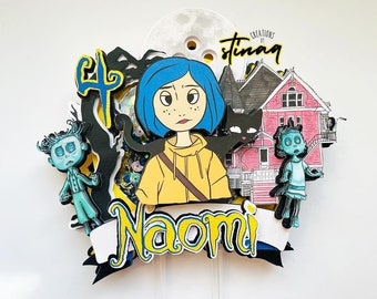 May include: A colorful cake topper featuring a cartoon character with blue hair, a yellow shirt, and a black cat. The topper also includes a pink house, a black and white moon, and the name "Naomi" in yellow letters.