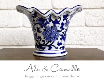 Blue white vase; add a touch of Chinoiserie charm with our scalloped ceramic vase, inspired by traditional motifs, creating elegance.