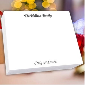 May include: White notepad with the text "The Wallace Family" at the top and "Craig & Laura" at the bottom.