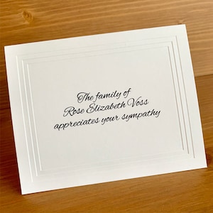 May include: White sympathy card with black text that reads "The family of Rose Elizabeth Voss appreciates your sympathy."