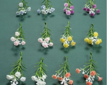 May include: Assortment of ten artificial flower stems with various colored blossoms. The flowers are arranged in two rows of five. The flowers are all different colors, including pink, yellow, blue, and white.