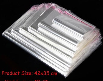 Puede incluir: Una pila de bolsas de plástico transparentes con un sello rojo. Las bolsas miden 42x35 cm y tienen un tamaño utilizable de 40x31 cm.
