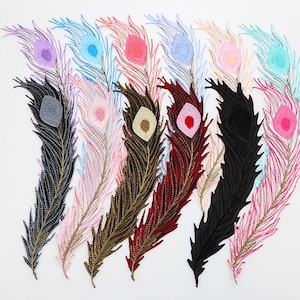 May include: Assortment of seven peacock feather embroidery patches in various colours, including black, pink, blue, red, and gold. The patches are all approximately 10 inches long and feature a detailed design.