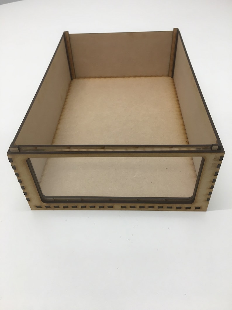 May include: A wooden box with a clear plastic window. The box is made of light brown wood and has a simple design.