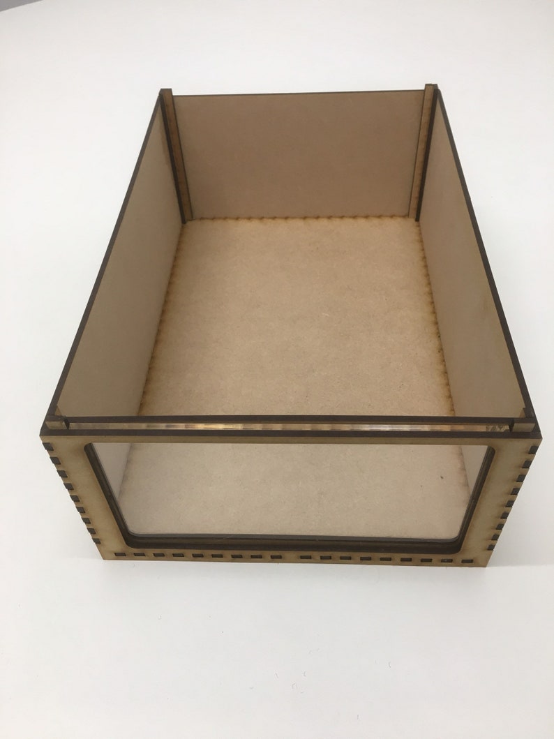 May include: A wooden display case with a clear glass front. The case is made of light brown wood and has a simple, rectangular design.