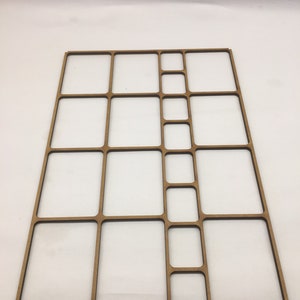 May include: A wooden organizer with multiple compartments of varying sizes. The organizer is made of light brown wood and has a rectangular shape.