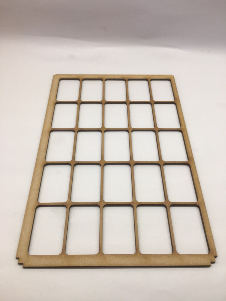 May include: A wooden frame with 24 rectangular openings, perfect for organizing small items like jewelry or craft supplies.