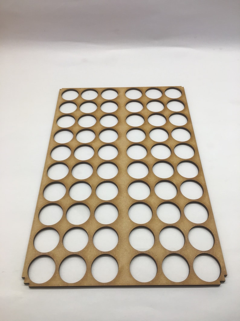 May include: A wooden paint pot holder with 48 round holes. The holder is light brown and has a smooth surface.