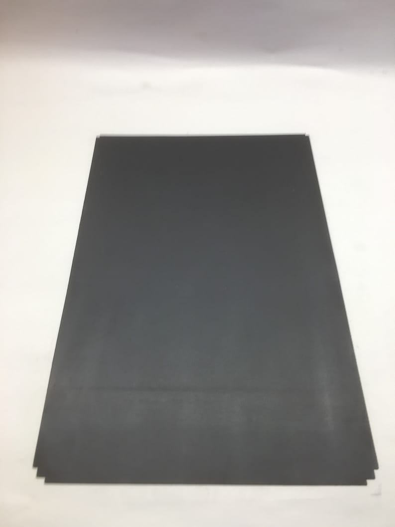 May include: A dark gray rectangular sheet of paper.