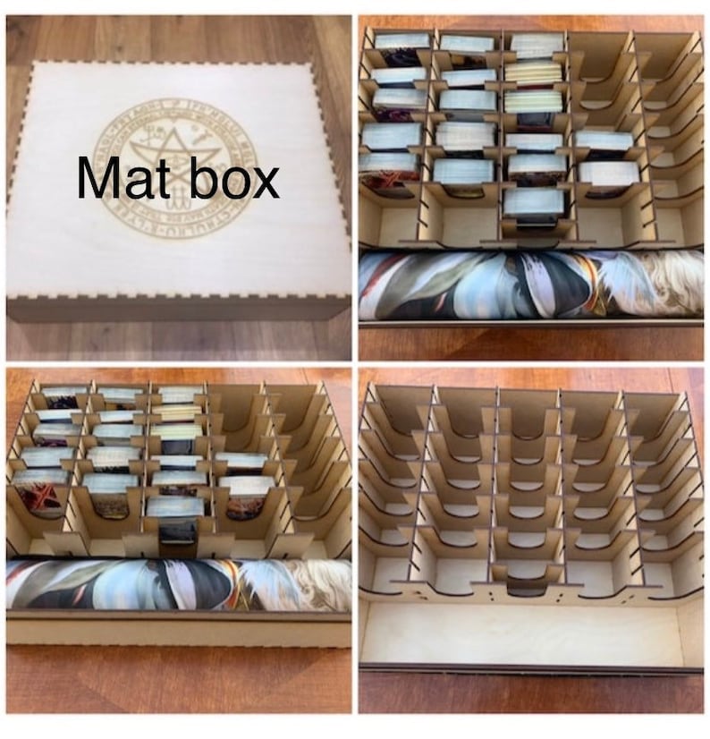 May include: A wooden box with a lid that has a circular design and the text "Mat box" engraved on it. The box is divided into compartments for storing cards. The box is shown open with a roll of fabric inside.