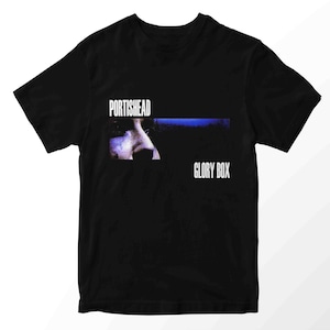 May include: Black t-shirt featuring the band name "Portishead" above a blue horizontal stripe and a close-up of a face. Below the stripe is the text "Glory Box" in white.