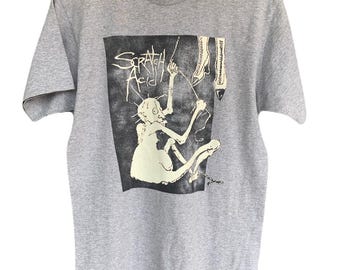 Camiseta estilo grunge con estampado de ácido y arañazos.