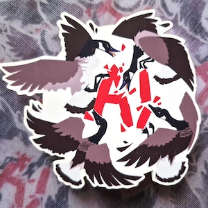 May include: A white sticker with a graphic of geese encircling the red letters "AI". The geese have black heads, grey wings, and white bodies. The letters are in a distressed font, suggesting a dynamic theme.