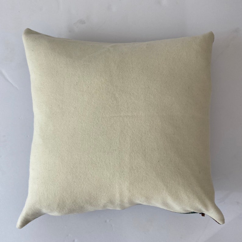 May include: A plain white pillow with a zipper closure on the back.